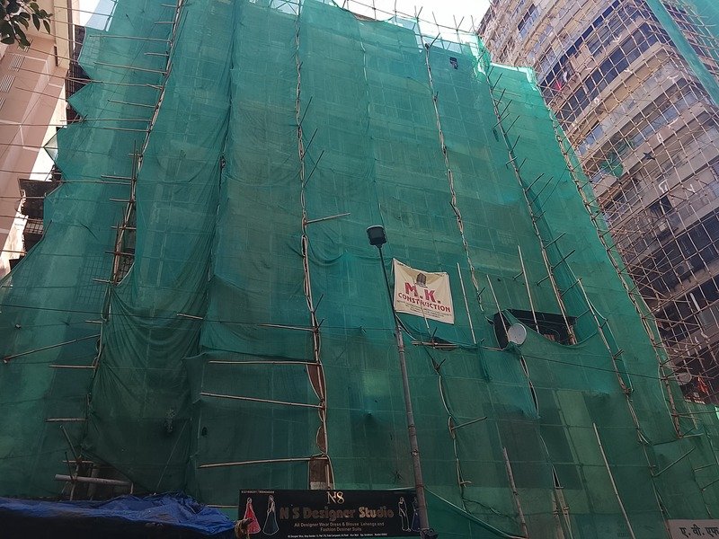 MK Constructions team reviewing blueprints on an active construction site